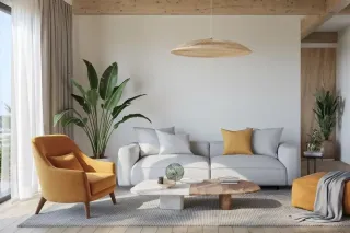 contactez_tryba.webp Un salon moderne et épuré avec un canapé gris, un fauteuil jaune, des plantes vertes et une table basse design sous un luminaire en os