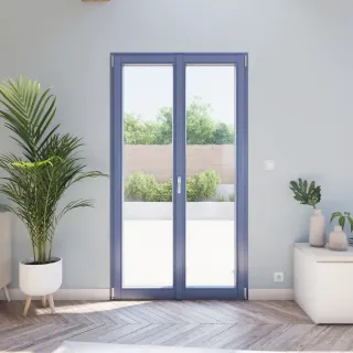 fenetres_coloris_personnalisable.webp Une porte-fenêtre moderne avec un cadre bleu donnant sur une terrasse ensoleillée, entourée de plantes vertes dans une pièce lumineuse.